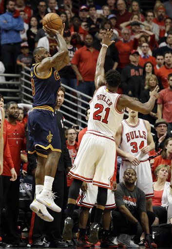 Cleveland Cavaliers' LeBron James, left, shoots the game-winning shot against Chicago Bulls guard Jimmy Butler during the second half of Game 4 in a second-round NBA basketball playoff series in Chicago on Sunday, May 10, 2015. The Cavaliers won 86-84. (AP Photo/Nam Y. Huh)