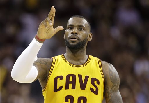 Cleveland Cavaliers forward LeBron James (23) celebrates a play against the Golden State Warriors during the second half of Game 3 of basketball's NBA Finals in Cleveland, Tuesday, June 9, 2015. (AP Photo/Tony Dejak)