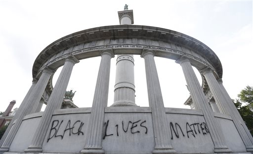 A spray painted message of Black Lives Matter was painted on a monument to former Confederate President Jefferson Davis on Monument Avenue in Richmond, Va., Thursday, June 25, 2015.  The vandalism comes after a mass shooting in Charleston South Carolina has sparked a nationwide debate on the public display of Confederate imagery.  (AP Photo/Steve Helber)