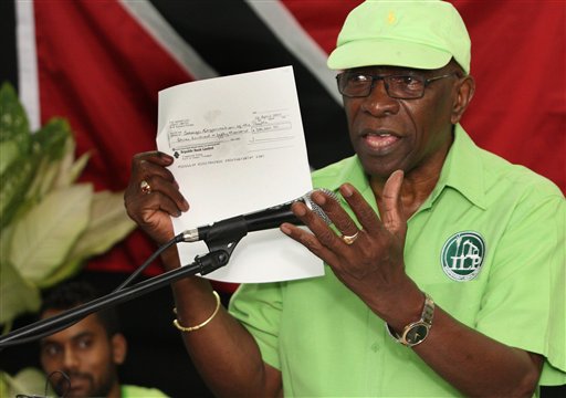 Former FIFA vice president Jack Warner hold a copy of a check while he speaks at a political rally in Marabella, Trinidad and Tobago, Wednesday, June 3, 2015. Warner made a televised address Wednesday night, saying he will prove a link between soccer's governing body and his nation's elections in 2010. Warner said he has documents and checks that link FIFA officials, including embattled President Sepp Blatter, to the 2010 election in Trinidad and Tobago. (AP Photo/Anthony Harris)