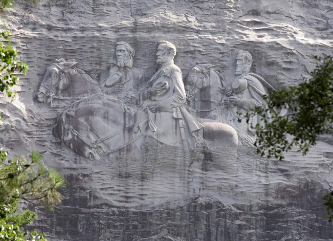 This photo shows a carving depicting confederates Stonewall Jackson, Robert E. Lee and Jefferson Davis, Tuesday, June 23, 2015, in Stone Mountain, Georgia. (AP Photo/John Bazemore)