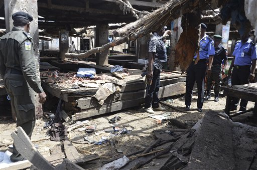 Police officers inspect the site of  a suicide bomb attack at a market in Maiduguri , Nigeria, Tuesday, June 2, 2015.  Boko Haram attacked the northeastern Nigerian city of Maiduguri on Tuesday with deafening explosions from the west and a suicide bombing near the center that witnesses said killed as many as 20 people. (AP Photo/Jossy Ola)