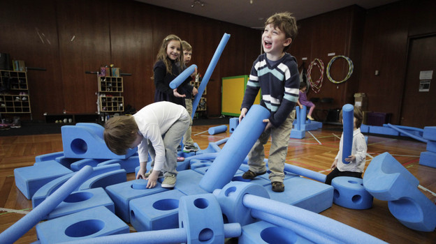 Children play with blue foam building blocks at the Blue School in New York City on March 31. The private preschool was founded by members of the Blue Man Group who wanted to send their own children to a school they felt supported creativity. (AP Photo)