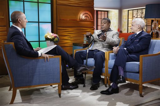 This photo provided by NBC shows, from left, Matt Lauer, Tracy Morgan, and Benedict Morelli appearing on NBC News' "Today" show on Monday, June 1, 2015 , in New York. The actor-comedian Morgan said Monday he doesn't remember anything about the limo accident that left him in a coma for two weeks, and said that, a year later, he still has bad days as well as good. Appearing live on the "Today" show for his first public appearance since the accident, Morgan sat clutching a cane and became emotional as he recalled learning after the crash June 7, 2014, that his fellow comedian, James "Jimmy Mack" McNair, was killed. (Peter Kramer/NBC via AP)