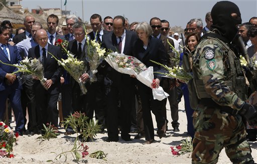 British Home Secretary Theresa May centre right, French Interior Minister Bernard Cazeneuve 2nd left, German Interior Minister Thomas de Maiziere 3rd left  joined their Tunisian counterpart  Mohamed Najem Gharsalli centre, on the beach in front of the Imperial Marhaba hotel in the Mediterranean resort of Sousse for a tribute in Sousse, Tunisa, Monday, June 29, 2015. The top security officials of Britain, France, Germany and Belgium are paying homage to the  people killed in the terrorist  attack on Friday. (AP Photo/Abdeljalil Bounhar)