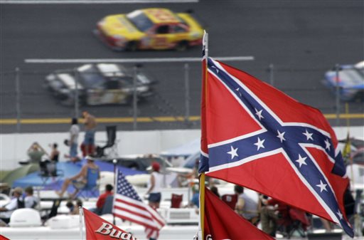 In this Oct. 7, 2007, file photo, a Confederate flags fly in the infield as cars come out of turn one during a NASCAR auto race at Talladega Superspeedway in Talladega, Ala. NASCAR is backing South Carolina Gov. Nikki Haley's call to remove the Confederate flag from the South Carolina Statehouse grounds in the wake of a massacre at a Charleston church, it said in a statement Tuesday, June 23, 2015. Though NASCAR bars the use of the flag in any official capacity, many fans fly the flag at their races. (AP Photo/Rob Carr, File)