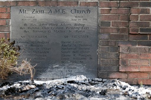Ashes lie by a cornerstone outside Mount Zion African Methodist Episcopal Church, Wednesday, July 1, 2015, in Greeleyville, S.C. The African-American church, which was burned down by the Ku Klux Klan in 1995, caught fire Tuesday night, but authorities said arson is not the cause. (Veasey Conway/The Morning News via AP)