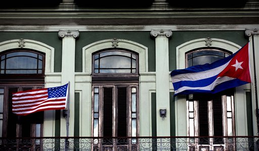 FILE - In this Jan. 19, 2015 file photo, a Cuban and American flag wave from the balcony of the Hotel Saratoga in Havana. President Barack Obama will announce July 1 that the U.S. and Cuba have reached an agreement to open embassies in Havana and Washington, a senior administration official said. (AP Photo/Ramon Espinosa, File)