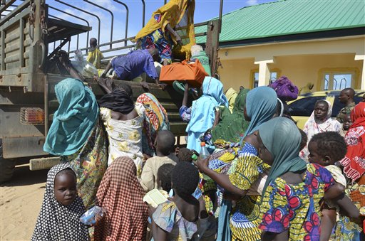 Women and children rescued by Nigerian soldiers from Boko Haram extremists in northeast Nigeria arrive at the military office in Maiduguri, Nigeria, Thursday, July 30, 2015. Soldiers rescued 71 people, almost all girls and women, in firefights that killed many Boko Haram militants in villages near the northeastern city of Maiduguri, Nigerias military said Thursday. (AP Photo/Jossy Ola)