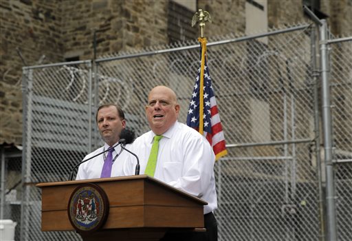 Maryland Gov. Larry Hogan speaks in front of Maryland Secretary of Public Safety and Correctional Services Stephen Moyer at Baltimore City Detention Center, Thursday, July 30, 2015, in Baltimore, to announce his plan to immediately shut down the jail. The jail grabbed headlines in 2013 after a sweeping federal indictment exposed a sophisticated drug- and cellphone-smuggling ring involving dozens of gang members and correctional officers. (AP Photo/Patrick Semansky)