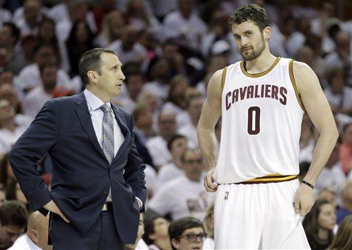 In this April 19, 2015, file photo, Cleveland Cavaliers head coach David Blatt, left, talks with Kevin Love (0) during an NBA playoff basketball game in Cleveland. A person familiar with the decision says Love has opted out of the final year of his contract and will be a free agent on July 1.  Love can test the market, where he will likely draw major interest, or stay in Cleveland and chase an NBA title with superstar LeBron James. (AP Photo/Mark Duncan, File)