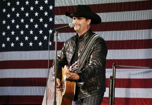 In this Nov. 2, 2009 file photo, John Rich of the musical group, Big & Rich, performs at a rally for 23rd Congressional District candidate, Doug Hoffman, in Watertown, N.Y. Mainstream country music has been quietly distancing itself from the Confederate flag for years, but as the debate reignites following a massacre at a black church in South Carolina on June 17, country artists still struggle to articulate their feelings about the flags history and symbolism. Rich told Fox News Sean Hannity that he agreed with South Carolina Gov. Nikki Haleys call to remove the Confederate flag from the state capitol. (AP Photo/Heather Ainsworth, File)