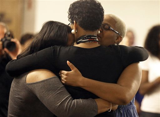 Geneva Reed-Veal, center, hugs family members at a memorial service for her daughter Sandra Bland at Prairie View A&M University, Tuesday, July 21, 2015, in Prairie View, Texas. A newly released dashcam video documents how a routine traffic stop escalated into a shouting confrontation between a Texas state trooper and Bland, which led to her arrest. Bland was found hanging in her jail cell three days after the incident. (AP Photo/Pat Sullivan)