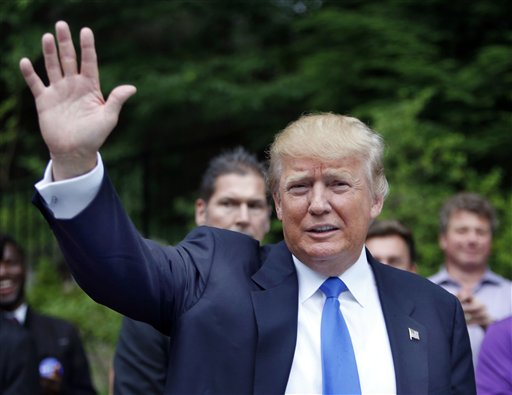 In this June 30, 2015, photo, Republican presidential candidate Donald Trump waves as he arrives at a house party in Bedford, N.H. Hispanic leaders are warning of harm to Republican White House hopes unless the partys presidential contenders do more to condemn Trump, whos refusing to apologize for calling Mexican immigrants rapists and drug dealers. (AP Photo/Jim Cole)