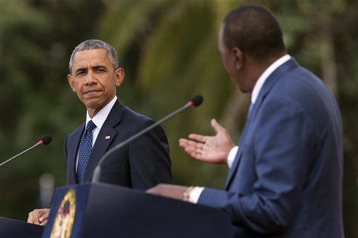 President Barack Obama, left, listens as Kenyan President Uhuru Kenyatta speaks during a news conference at State House, on Saturday, July 25, 2015, in Nairobi, Kenya. Obama nudged African nations Saturday to treat gays and lesbians equally under the law, a position that remains unpopular through much of the continent.  (AP Photo/Evan Vucci)