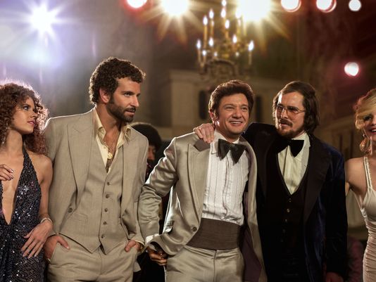 This film image released by Sony Pictures shows, from left, Amy Adams, Bradley Cooper, Jeremy Renner, Christian Bale and Jennifer Lawrence in a scene from "American Hustle." (Francois Duhamel/AP Photo)