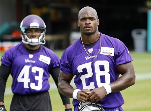 In this Wednesday, June 17, 2015,  file photo, Minnesota Vikings running back Adrian Peterson (28) walks across the field during NFL football minicamp in Eden Prairie, Minn. The sideshow that overshadowed last season has been dismantled, following Peterson's reinstatement from NFL suspension. (AP Photo/Ann Heisenfelt, File)