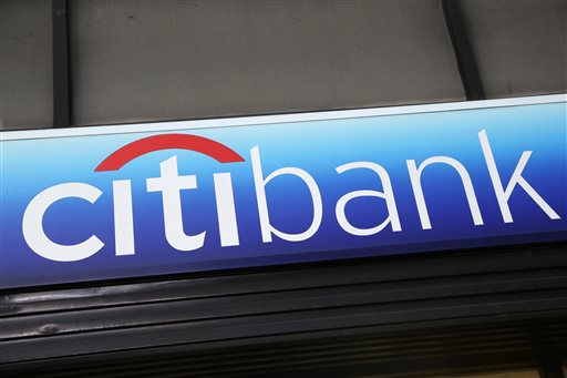 In this Jan. 15, 2015 photo, a Citibank sign hangs above a branch office in New York. The Consumer Financial Protection Bureau on Tuesday, July 21, 2015 said that Citi will have to issue refunds to 8.8 million affected consumers who paid for credit card add-on products and services, like credit score monitoring or "rush" processing of payments. (AP Photo/Mark Lennihan, File)