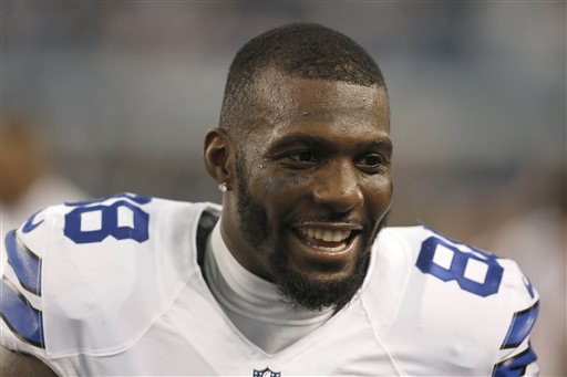 In this Jan. 4, 2015, file photo, Dallas Cowboys wide receiver Dez Bryant (88) talks to his teammates on the sideline during the first half of an NFL wildcard playoff football game against the Detroit Lions in Arlington, Texas. Dez Bryant sounds willing to skip training camp and possibly regular-season games without a long-term contract. Wednesday, July 15, 2015,  is the deadline to get it. (AP Photo/Brandon Wade, File)