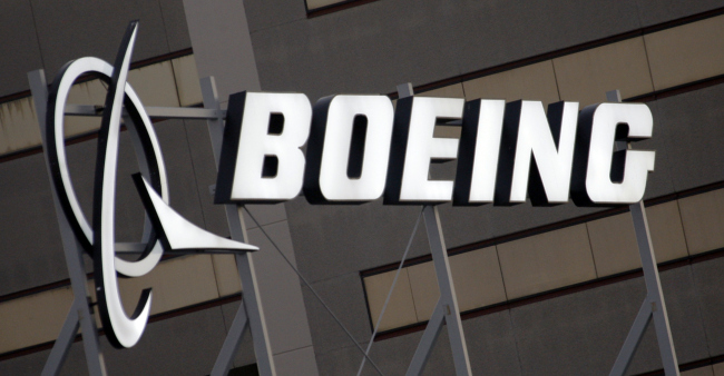 In this Jan. 25, 2011 file photo is the Boeing Company logo on the property in El Segundo, Calif. (AP Photo/Reed Saxon, File)