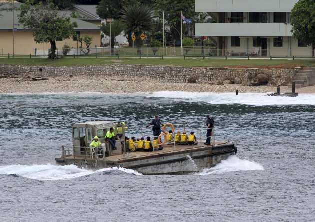 On April 14, 2013, a group of Vietnamese asylum seekers are taken by barge to a jetty on Australia's Christmas Island. (AP Photo)