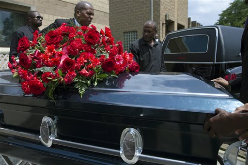 The casket of Samuel Dubose is transported to a hearse during his funeral at the Church of the Living God in the Avondale neighborhood of Cincinnati, Tuesday, July 28, 2015. Dubose was fatally shot by a University of Cincinnati police officer who stopped him for a missing license plate. (AP Photo/John Minchillo)