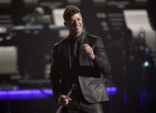 In this Sunday, June 28, 2015 file photo, Robin Thicke performs during a tribute to Smokey Robinson at the BET Awards at the Microsoft Theater in Los Angeles. A federal judge in Los Angeles on Tuesday, July 14, 2015, trimmed a copyright infringement verdict against Thicke and Pharrell Williams over their 2013 hit "Blurred Lines" from nearly $7.4 million to $5.3 million. The ruling also gives Marvin Gaye's family, which sued the singers over the song, an ongoing shared of royalties from "Blurred Lines."  (Photo by Chris Pizzello/Invision/AP, File)