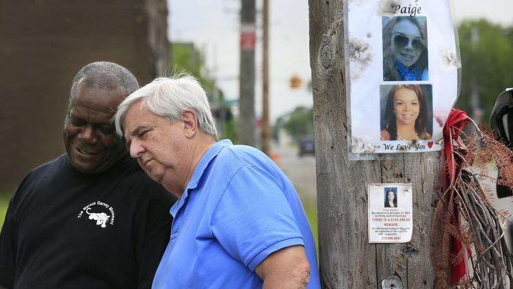 Dave Lawrence, right, and Steven Goodin share a moment after a prayer at the site where Lawrence's 16-year-old granddaughter Paige Stalker was killed. (Carlos Osorio/AP Photo)