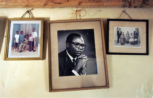 In this Thursday, Feb. 5, 2008 file photo, a photograph of Barack Obama Sr., father of President Barack Obama, hangs on the wall of his step-grandmother Sarah Obama's house in the village of Kogelo, near the shores of Lake Victoria, in Kenya. On Friday, July 24, 2015 Obama is due to arrive in Kenya, the country of his father's birth, for the first time since he was a U.S. senator in 2006, and the first stop on his two-nation African tour in which he will also visit Ethiopia. (AP Photo/Ben Curtis, File)