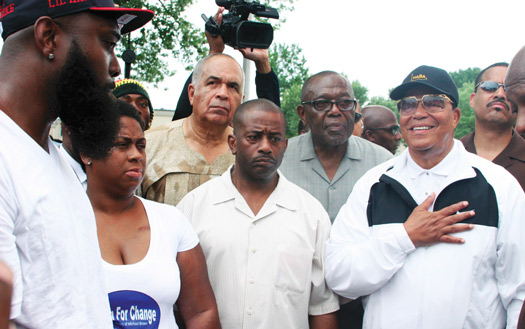 Minister Farrakhan greets Michael Brown Sr. (far left) the father of slain 18-year-old Michael Brown Jr. at the Canfield Green Apartments, near the spot where the teen was killed August 9, 2014. (Andrea Muhammad/The Final Call)
