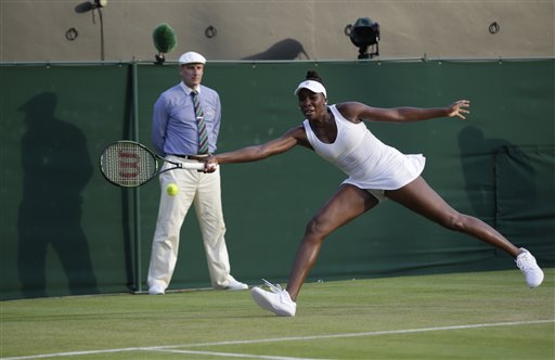 Venus Williams of the United States returns a shot to Yulia Putintseva of Kazakhstan  during their singles match at the All England Lawn Tennis Championships in Wimbledon, London, Wednesday July 1, 2015. (AP Photo/Pavel Golovkin)