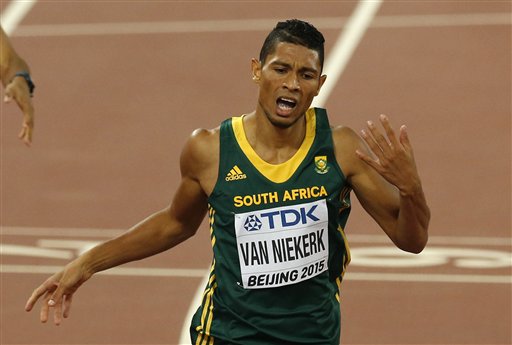 South Africa's Wayde Van Niekerk crosses the line to take the gold medal in the men's 400m final during the World Athletics Championships at the Bird's Nest stadium in Beijing, Wednesday, Aug. 26, 2015. (AP Photo/Mark Schiefelbein)