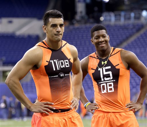 In this Feb. 21, 2015, file photo, then-Oregon quarterback Marcus Mariota (11) and then-Florida State quarterback Jameis Winston (15) wait to run a drill at the NFL football scouting combine in Indianapolis. Its time for Winston and Mariota to show what theyve been learning at training camp in their preseason debuts. (AP Photo/David J. Phillip, File)