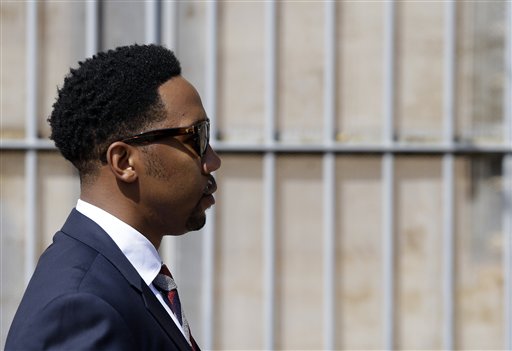 Grandson of former South African president Nelson Mandela, Ndaba Mandela walks out of the magistrates court where his brother Mbuso Mandela is scheduled to appear accused of raping a 15-year-old girl, in Johannesburg, South Africa, Friday, Aug. 21, 2015.  The grandson of Nelson Mandela, Mbuso Mandela appeared in court accused of raping a 15-year-old girl, where a judge will decide whether he will be granted bail.  (AP Photo/Themba Hadebe)