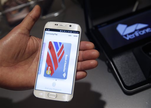 In this Aug. 6. 2015, photo, a Samsung employee demonstrates Samsung Pay using a Galaxy S6 Edge Plus in New York. (AP Photo/Seth Wenig)
