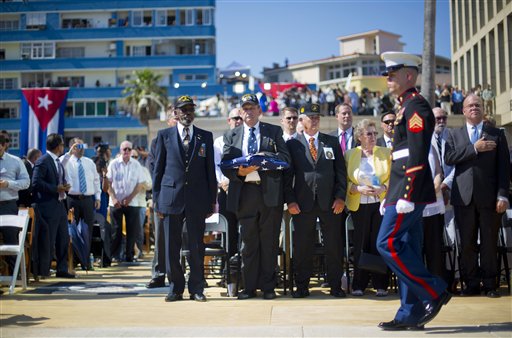 Retired Marines, from left, Gunnery Sgt. Francis 'Mike' East, Gunnery Sgt. James Tracy, and Cpl. Larry Morris, wait to present the U.S. flag to Marines currently stationed in Cuba, during the raising of the U.S. flag over the newly reopened embassy in Havana, Cuba. Friday, Aug. 14, 2015. East, Tracy and Morris where part of the Marines that had originally lowered the American flag in 1961 and promised to return the flag. (AP Photo/Pablo Martinez Monsivais, Pool)