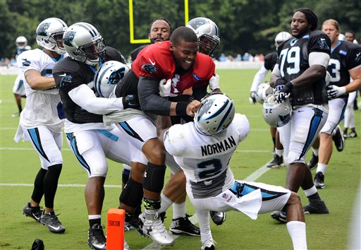 Carolina Panthers' Cam Newton (1) and Josh Norman (24) scuffle at the teams NFL football training camp at Wofford College in Spartanburg, S.C., Monday, Aug. 10, 2015. (David T. Foster III/The Charlotte Observer via AP)