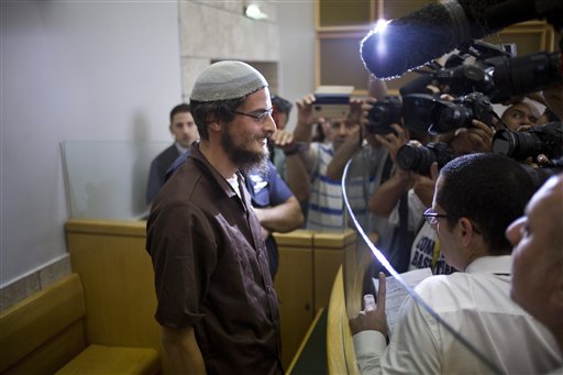 Head of a Jewish extremist group Meir Ettinger appears in court in Nazareth Illit , Israel, Tuesday, Aug. 4, 2015. Israel said Tuesday it was interrogating the suspected head of a Jewish extremist group in the first arrest of an Israeli suspect following last week's arson attack in the West Bank that killed a Palestinian toddler and wounded his brother and parents. According to the Shin Bet security agency, 23-year-old Ettinger was arrested late Monday for "involvement in an extremist Jewish organization." (AP Photo/Ariel Schalit)