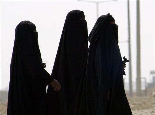 In this Nov. 15, 2006, file photo, Saudi women walk along a suburban street in Riyadh, Saudi Arabia. A video uploaded online in July 2015 that shows two young Saudi women being harassed by several young men on a seaside promenade in the coastal city of Jiddah has sparked a rare public debate on the rights of women in this ultra-conservative Muslim country that imposes a strict segregation of the sexes. (AP Photo/Hasan Jamali, File)