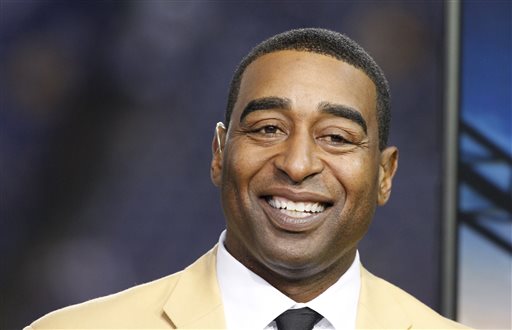 This is a Nov. 7, 2013, file photo showing Cris Carter smiling in the NFL booth during the first half of an NFL football game between the Minnesota Vikings and Washington Redskins in Minneapolis. Hall of Fame receiver Cris Carter has issued an apology for telling NFL rookies at a league symposium in 2014 that they should "get a fall guy" to help them avoid trouble. Carter posted his apology on Twitter after an ESPN article drew attention to the remarks he made during a presentation last year. (AP Photo/Ann Heisenfelt, File)
