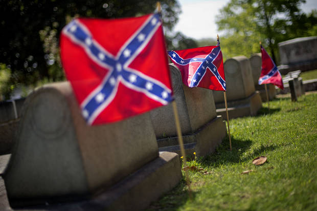 Confederate flags are planted next to the graves of Confederate soldiers in Oakland cemetery, Monday, April 22, 2013, in Atlanta. Georgia observes Confederate Memorial Day Monday marking the anniversary of the end of the Civil War. While April 26th is officially recognized as Confederate Memorial Day, state offices are closed Monday in observance of the holiday. (AP Photo/David Goldman)