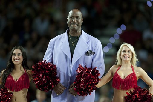 FILE - In this Oct. 6, 2013, file photo, former Philadelphia's 76ers' Darryl Dawkins, center, receives a tribute before a match against Bilbao Basket, during an NBA Global basketball game in Bilbao, northern Spain. Darryl Dawkins, whose backboard-shattering dunks earned him the moniker "Chocolate Thunder" and helped pave the way for breakaway rims, has died. He was 58. The Lehigh County, Pennsylvania coroner's office said Dawkins died Thursday morning, Aug. 27, 2015, at a hospital. (AP Photo/Alvaro Barrientos, File)