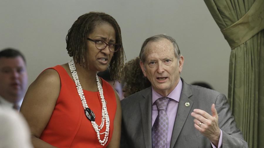 Sen. Holly Mitchell (D-Los Angeles) and Assemblyman Bill Quirk (D-Hayward) discuss her measure that would end the use of grand jury proceedings to investigate police shootings after it failed to get enough votes for passage on the first vote in the Assembly, on July 16 in Sacramento The bill was finally approved on a second vote, 41-33 and was signed by Gov. Jerry Brown on Tuesday. (Rich Pedroncelli/AP Photo)