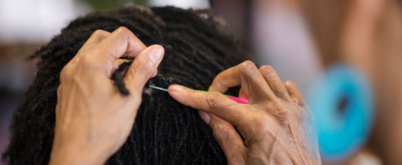 Ayana Hardin creates natural hair twists. (Erin Mizelle/Winston-Salem Chronicle)