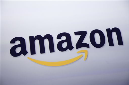 In this Sept. 28, 2011 file photo, the Amazon.com logo is displayed at a news conference in New York. The e-commerce powerhouse on Tuesday, Sept. 1, 2015 said it will now let members of its $99 annual Prime loyalty program download some shows and movies on its streaming video service to watch offline, or when there is no Internet connection available, for free. (AP Photo/Mark Lennihan, File)