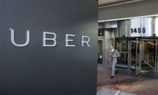In this photo taken Tuesday, Dec. 16, 2014, a man leaves the headquarters of Uber in San Francisco. A federal judge granted class-action status Tuesday, Sept. 1, 2015, to a lawsuit in California against Uber over the payment of its drivers, upping the stakes for the ride-hailing company in the case. (AP Photo/Eric Risberg, File)