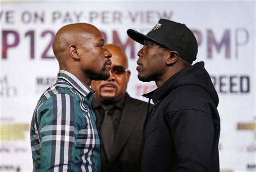 Boxers Floyd Mayweather Jr., left, and Andre Berto pose for photographers during a news conference Wednesday, Sept. 9, 2015, in Las Vegas. The pair are scheduled to fight Saturday for Mayweather's WBC and WBA Super World welterweight titles.   (AP Photo/John Locher)