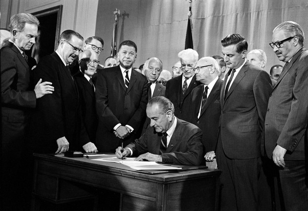 President Lyndon B. Johnson signs the Fair Housing Act into law in 1968. (AP Photo)
