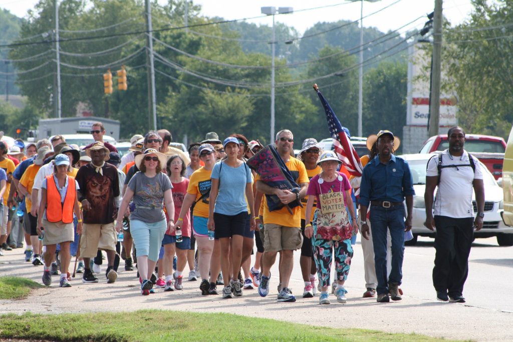 Journey for Justice marchers travel down Wilmington Street toward the State Capitol building in Raleigh. The march was led by 85-year-old Ruth Zalph (left), wearing a Black Lives Matter sign and Cornell William Brooks (right), president of NAACP. (Photos by Afrique Kilimanjaro/Carolina Peacemaker)