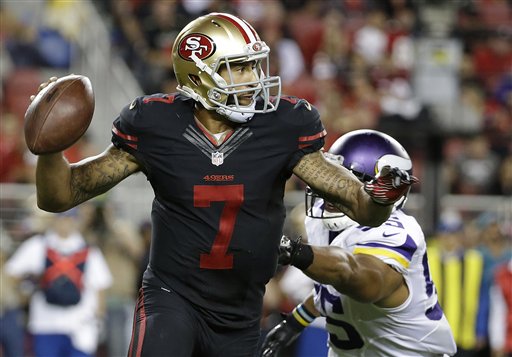 San Francisco 49ers quarterback Colin Kaepernick (7) rolls out to pass as Minnesota Vikings outside linebacker Anthony Barr (55) applies pressure during the second half of an NFL football game in Santa Clara, Calif., Monday, Sept. 14, 2015. (AP Photo/Marcio Jose Sanchez)